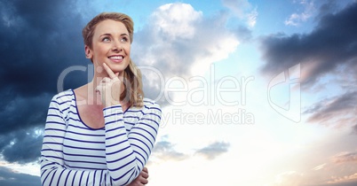 Thoughtful woman looking away against sky