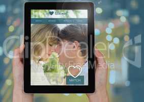 Hand holding a tablet with Dating App Interface