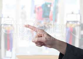 Hand pointing in  air of  clothes retail store