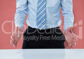Midsection of businessman gesturing at table