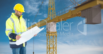 Architect holding blueprint against crane