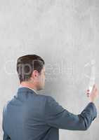 Businessman using smart phone against gray background