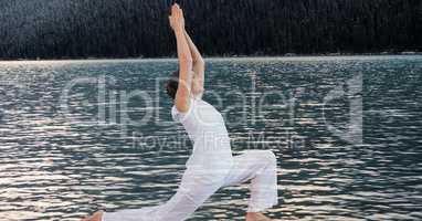 Double exposure of woman performing yoga by lake