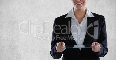 Midsection of businesswoman holding transparent digital tablet