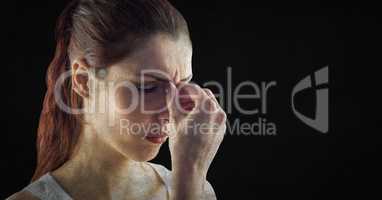 Close up of stressed woman against black background with grunge overlay