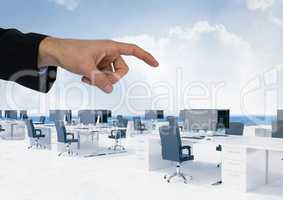 Hand pointing in  air of office desks with sky
