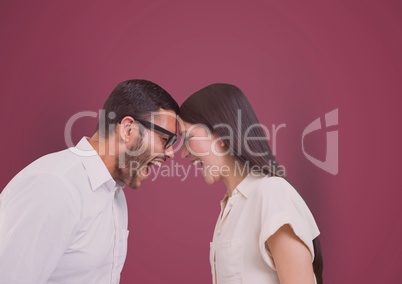 Business colleagues with head to head screaming over pink background