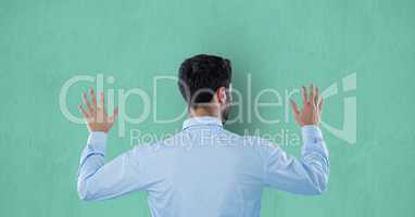 Rear view of businessman touching colored background