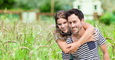 Happy young woman embracing man on field