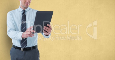 Midsection of businessman holding digital tablet