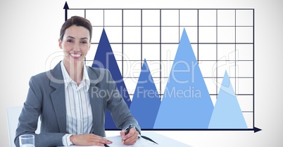 Businesswoman smiling with graph in background