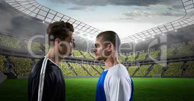 Side view of soccer players looking at each other at stadium