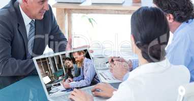 Business people video conferencing with colleagues on laptop