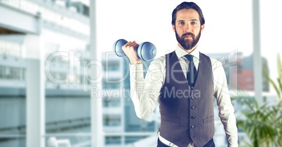 Confident man lifting dumbbell in city