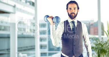 Confident man lifting dumbbell in city