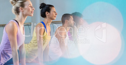 People performing yoga at gym