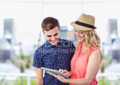 Male and female hipsters using digital tablet