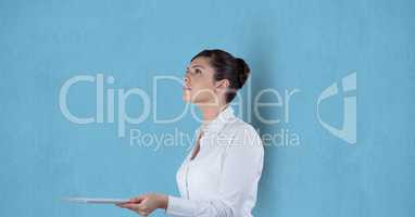 Businesswoman holding digital tablet over blue background