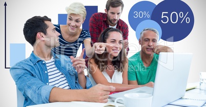 Casual business people using laptop with graphs in background