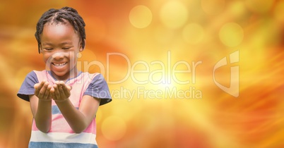 Happy girl with cupped hands over blurred background