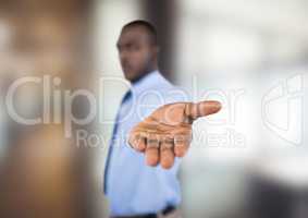 Businessman showing hand over blur background