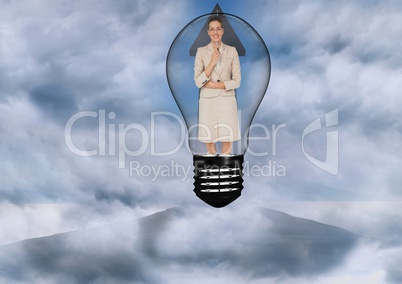Businesswoman in light bulb surrounded by clouds