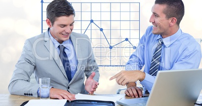 Smiling business people talking against graph