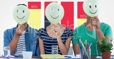 Casual business people holding balloon in front of faces against graph