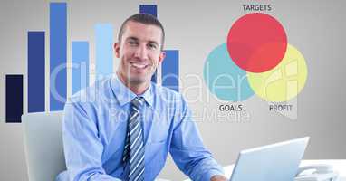 Smiling businessman with laptop against graphics