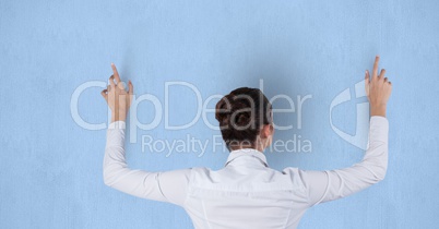 Rear view of businesswoman touching blue background