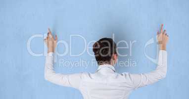 Rear view of businesswoman touching blue background