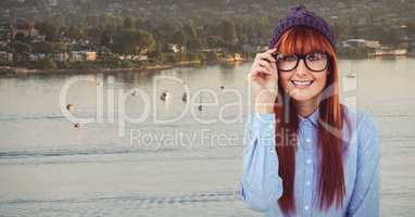 Female hipster wearing eyeglasses against lake