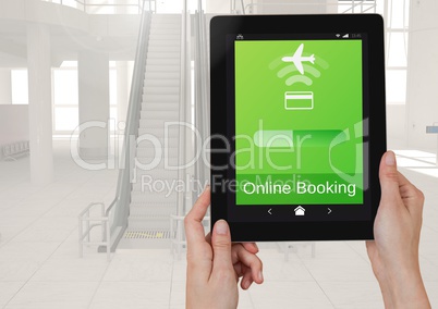 Hands holding a tablet and an Online Booking Flight App Interface