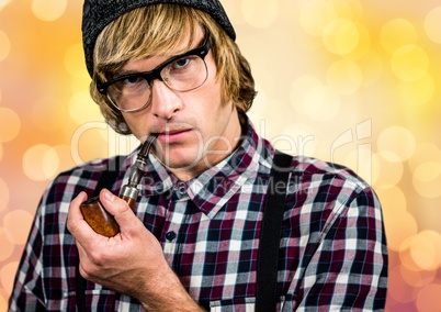 Male hipster smoking pipe over bokeh