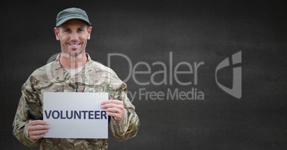 Soldier volunteer against grey wall