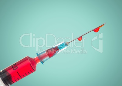 Syringe with red liquid against aqua background