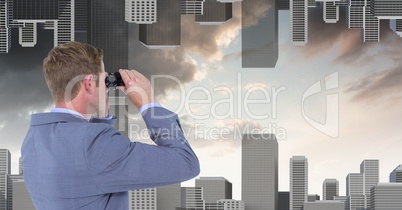 Businessman looking at upside down city through binoculars