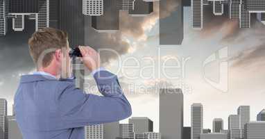 Businessman looking at upside down city through binoculars