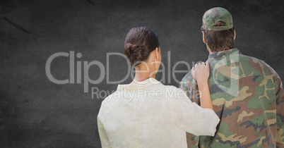 Back of soldier and wife against grey wall with grunge overlay