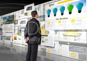 panels with websites(yellow), dark background, business man looking the panels