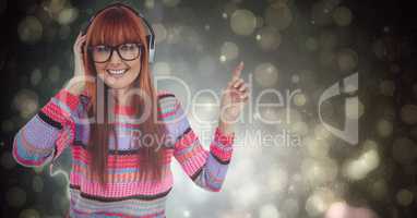 Happy female hipster listening to music over bokeh