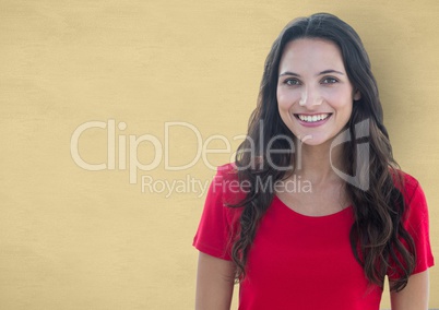 Portrait of young woman smiling over beige background