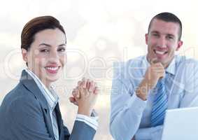 Confident male and female colleagues in office