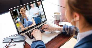 Businesswoman video conferencing with colleague on laptop
