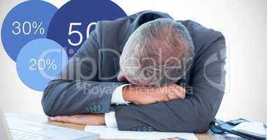 Businessman sleeping on desk by graphics