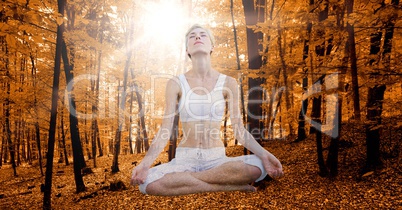 Double exposure of woman meditating in autumn forest