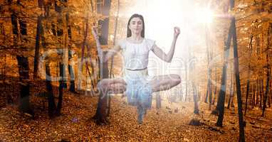 Double exposure of woman meditating in midair at autumn forest