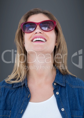 Close up of woman in sunglasses against grey background