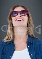 Close up of woman in sunglasses against grey background