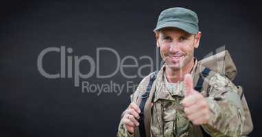 Soldier thumbs up against navy chalkboard